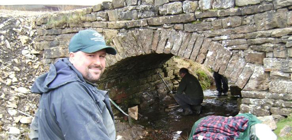 Volunteer helping with bridge repairs