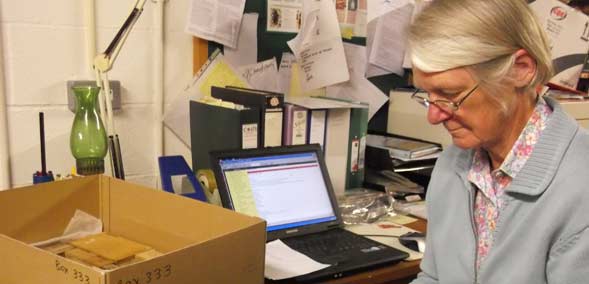 DCM Volunteer, Janet Thompson, working in the artefacts store room at the Museum